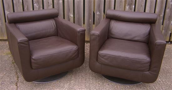 A pair of Natuzzi leather swivel armchairs W.77cm